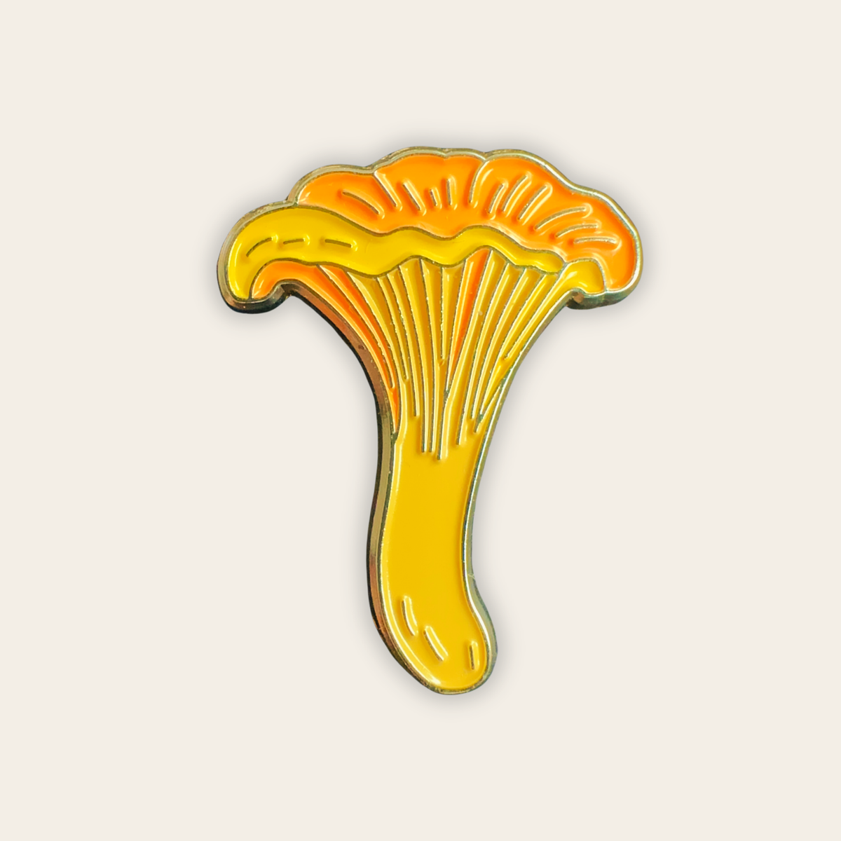 Chanterelle mushroom enamel pin in yellow and orange with gold-tone outline
